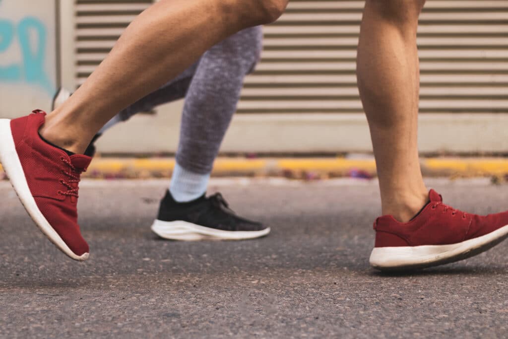 a young couple running in the middle of the street.